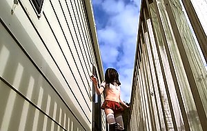 Crossdressing as school gurl on outdoor deck