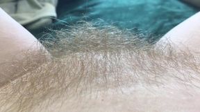 Blonde babe shows off her hairy bush in a close-up