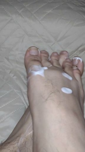 He massages his feet with white cum