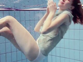 Small cute Nastya swims underwater stripped