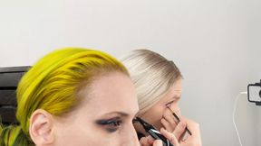 Crossdresser and Woman Putting on Eyeliner