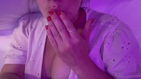 Hot milf is lying on her bed and pleases her pussy with her fingers