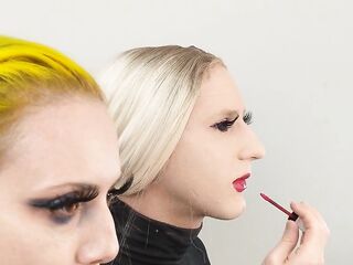 Crossdresser and Woman Putting on Lipliner and Lipstick
