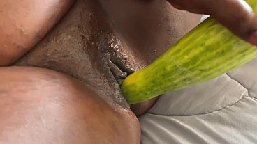 Pregnant African Lesbian fucks her tight pussy with a big cucumber and cream on it until she cum
