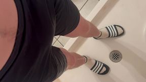 amateur boy in white socks and adidas slides wetting his blue shorts - pov (filmed by himself)