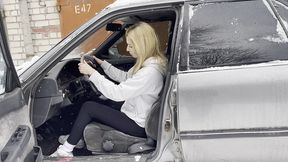 Milana pumping the pedals of a Toyota Carina in her white sneakers
