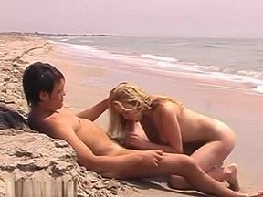 Blond girl riding at the beach