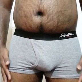 A horny Black Asian guy exercise with a stone to get a big dick