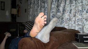 i chill on the living room couch with my feet propped up