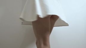 A girl in a white dress enjoys a big rubber toy in a solo session.