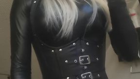 Smoking in tight leather corset and catsuit