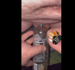 Chub pees in bottle with a hollow sound in his tiny cock and then plays with it a little.