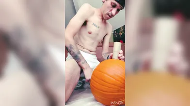 Skinny tatted boy carving & shags a pumpkin