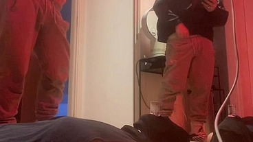 Amateur boy pissing in a glass held in his friend's mouth
