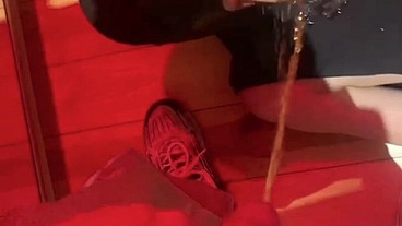 Amateur boy pissing in a glass held in his friend's mouth
