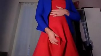 Young amateur cross dresser teasing and touching in a sexy red dress and cute blue blazer back from the office