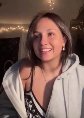 Smiling woman in a white hoodie