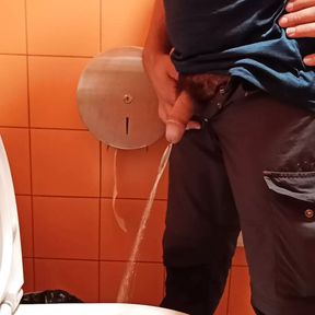 Pissing in an orange public toilet