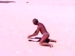 Tanned guy on beach in tiny string thong (temporarily!)