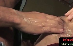 Hot gay stud plunges his fist in slaves ass