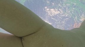 Curvy milf plays with ass play plug in public pool