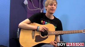 Young man plays guitar before dick stroking and cumming