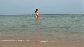 Slender beauty walks along the beach and swims in the sea. meet me