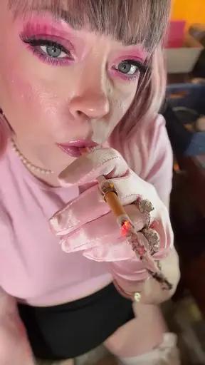 Pink satin gloves-clad chubby girl smokes cigarette