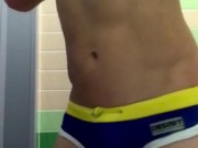 Athletic twink in swim trunks