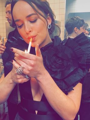 Slim fetish celebrity smokes a cigarette seductively