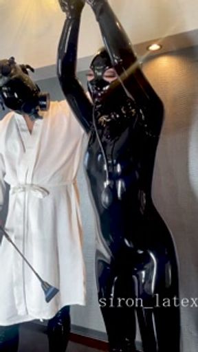 Lift the collar of the suspended latex doll and even more toys make her feel good