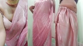 indian gay crossdresser gaurisissy pressing and playing with her big boobs looking in pink saree looking like a housewife