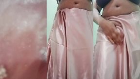 indian gay crossdresser gaurisissy pressing and playing with her big boobs looking in pink saree looking like a housewife