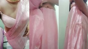 indian gay crossdresser gaurisissy pressing and playing with her big boobs looking in pink saree looking like a housewife