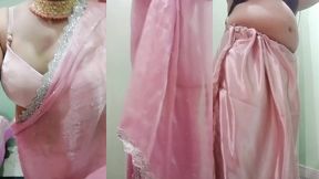 indian gay crossdresser gaurisissy pressing and playing with her big boobs looking in pink saree looking like a housewife