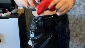 girl in latex and heels poping red balloons