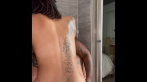 Riding her strap in the shower (Close up)