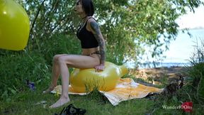 Sit pop big helium balloons on the lake shore **4K**