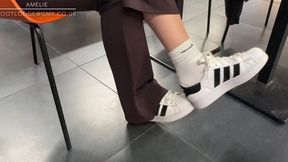 Candid shoeplay and dangling in Adidas sneakers and Nike white socks at the airport