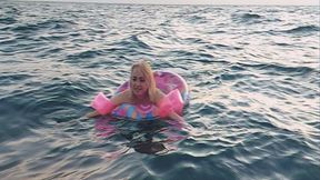 Alla swims in the sea with an inflatable ring and inflatable arm bands for safety!!!