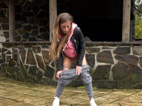 Naturally hot and pretty girl in grey pants wanna pee outdoors