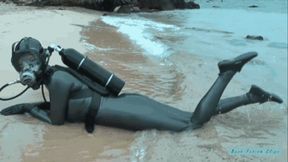 Rubber diving in latex catsuit and beach posing