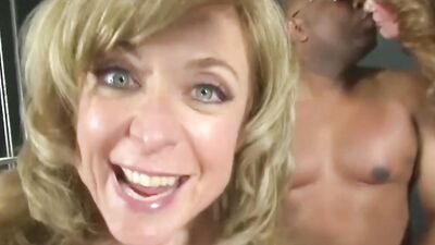 Two busty white MILFs in lingerie share a huge black cock