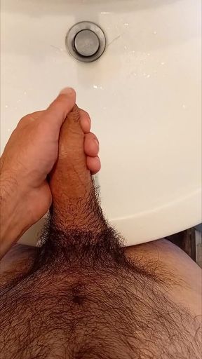 I play with my cock while I pee