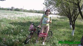 Peeing on her bicycle