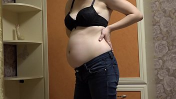 Pregnant milf takes off her tight jeans, puts on a sexy outfit, and masturbates her hairy pussy with a dildo. Homemade fetish and juicy booty with a hairy asshole.