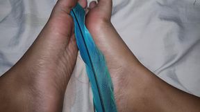feet dirty with a macaw feather