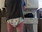 Baby wets diaper while washing dishes