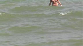 Hot German blonde rubbing her moist pussy on the beach
