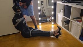 Girl in Leather Catsuit, High Heels and Latex Mask Is Gagged and in Tape Bondage for Her First Time